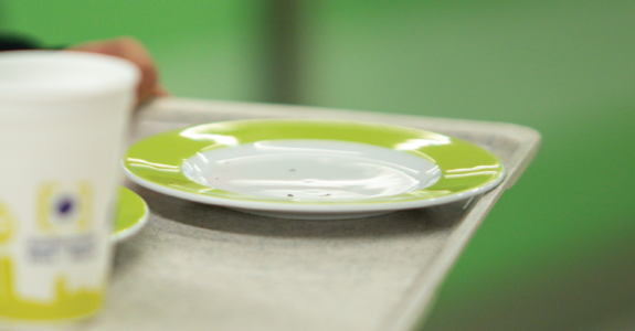 a photo of a plate - like those that disappeared from Bambus mensa on a tray, also visible one of the plastic coffee cups